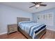 Bright bedroom with hardwood floors, shuttered windows, and natural finish furniture at 13575 Clara Ln, Port Charlotte, FL 33981