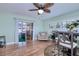 Bright dining area featuring hardwood floors, sliding doors, and an accent chair at 13575 Clara Ln, Port Charlotte, FL 33981