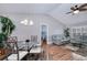 Bright dining room with hardwood floors, vaulted ceilings, a modern chandelier, and an open floor plan at 13575 Clara Ln, Port Charlotte, FL 33981