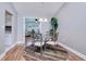 Cozy dining room with hardwood floors, with an open floor plan that flows into the living room at 13575 Clara Ln, Port Charlotte, FL 33981