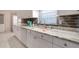 Modern kitchen features stainless steel appliances, granite countertops, white cabinets, and tile flooring at 13575 Clara Ln, Port Charlotte, FL 33981