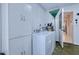 Laundry room features washer, dryer, utility sink and ample cabinet space at 13575 Clara Ln, Port Charlotte, FL 33981