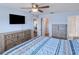 Bright main bedroom with ceiling fan, tv, and ensuite bathroom at 13575 Clara Ln, Port Charlotte, FL 33981
