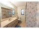 Bathroom with floral wallpaper, bath mat, and a toilet at 1497 Fireside St, Port Charlotte, FL 33952