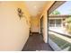 Covered entryway with brick flooring and space for decor at 1497 Fireside St, Port Charlotte, FL 33952