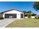 Charming single-story home featuring a one-car garage, well-kept lawn, and inviting entrance, enhancing curb appeal at 1497 Fireside St, Port Charlotte, FL 33952