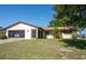 Charming single-story home with a well-manicured lawn and an attached two-car garage at 1497 Fireside St, Port Charlotte, FL 33952