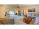 Spacious living room with vaulted ceilings, neutral carpet, and comfortable seating arrangements at 1497 Fireside St, Port Charlotte, FL 33952