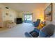 Carpeted living room with two recliners and sliders to the patio at 1497 Fireside St, Port Charlotte, FL 33952