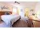 Comfortable main bedroom featuring neutral walls, ceiling fan, and ensuite bathroom at 1497 Fireside St, Port Charlotte, FL 33952