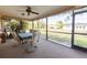 Screened-in patio with ceiling fan and outdoor seating perfect for relaxing at 1497 Fireside St, Port Charlotte, FL 33952