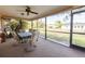 Screened patio with seating and view of the fenced backyard at 1497 Fireside St, Port Charlotte, FL 33952