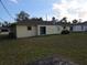 The exterior features a sliding glass door and large backyard at 18054 Ackerman Ave, Port Charlotte, FL 33948