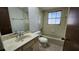 Well-lit bathroom with tile accents, a shower-tub combo, and a vanity at 18054 Ackerman Ave, Port Charlotte, FL 33948