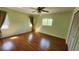 Bedroom featuring wood floors, a ceiling fan, windows, and a closet, creating a cozy atmosphere at 18054 Ackerman Ave, Port Charlotte, FL 33948