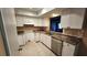 The kitchen has stainless steel appliances, light cabinetry and a tile backsplash at 18054 Ackerman Ave, Port Charlotte, FL 33948