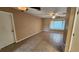 Spacious living room features a ceiling fan and a sunny window nook, creating a bright and airy atmosphere at 18054 Ackerman Ave, Port Charlotte, FL 33948