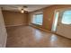 Open living space with tile floors, a ceiling fan, and a bay window at 18054 Ackerman Ave, Port Charlotte, FL 33948