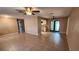 Open-concept living space with neutral tones, tile flooring, and french doors to backyard at 18054 Ackerman Ave, Port Charlotte, FL 33948