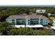 Aerial view of condominium building featuring balconies and parking at 19385 Water Oak Dr # 302, Port Charlotte, FL 33948