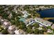 Community aerial view featuring pool, tennis courts, and lake at 19385 Water Oak Dr # 302, Port Charlotte, FL 33948