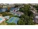 Aerial view of community showing pool, tennis court and lake at 19385 Water Oak Dr # 302, Port Charlotte, FL 33948
