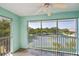 Relaxing screened balcony overlooking lush landscaping and tennis courts with a ceiling fan at 19385 Water Oak Dr # 302, Port Charlotte, FL 33948