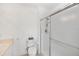 Bathroom with walk-in shower featuring glass doors and tile surround at 19385 Water Oak Dr # 302, Port Charlotte, FL 33948