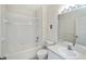 Bright bathroom featuring a tiled shower-tub combination, modern sink vanity, and neutral decor at 19385 Water Oak Dr # 302, Port Charlotte, FL 33948