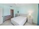 This bedroom has a ceiling fan, carpeted floors, and an ensuite bathroom with a walk-in shower at 19385 Water Oak Dr # 302, Port Charlotte, FL 33948