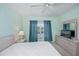 Cozy bedroom with a ceiling fan, dresser, and a bright window with pleasant natural lighting at 19385 Water Oak Dr # 302, Port Charlotte, FL 33948