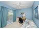 Bedroom with a ceiling fan, natural light, a workspace, and comfortable seating at 19385 Water Oak Dr # 302, Port Charlotte, FL 33948