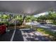 Well-maintained community carport providing covered parking, set among lush greenery at 19385 Water Oak Dr # 302, Port Charlotte, FL 33948