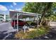 Community carport featuring covered parking spaces and landscaped surroundings for residents at 19385 Water Oak Dr # 302, Port Charlotte, FL 33948