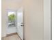 Bright entryway featuring a white door with window and neutral tile flooring at 19385 Water Oak Dr # 302, Port Charlotte, FL 33948
