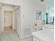 Hallway with bathroom access, closet, and a small workspace at 19385 Water Oak Dr # 302, Port Charlotte, FL 33948