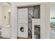 Laundry room with a washer, dryer, water heater, and storage space at 19385 Water Oak Dr # 302, Port Charlotte, FL 33948