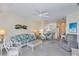 Comfortable living room showcasing a floral sofa and open layout into the kitchen at 19385 Water Oak Dr # 302, Port Charlotte, FL 33948