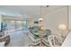 Well-lit living room with large sliding doors, ceiling fan, and adjacent dining area at 19385 Water Oak Dr # 302, Port Charlotte, FL 33948