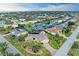 Scenic aerial view highlighting a waterfront home with lush landscaping and canal access in a well-maintained community at 200 Capri Isles Ct, Punta Gorda, FL 33950