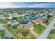 Aerial view showcasing a waterfront home with lush landscaping and canal access in a vibrant community at 200 Capri Isles Ct, Punta Gorda, FL 33950