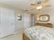 Bedroom featuring a ceiling fan, two closets, and a dresser with mirror at 200 Capri Isles Ct, Punta Gorda, FL 33950