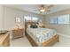 Cozy bedroom with neutral walls, ceiling fan, and coordinated furnishings at 200 Capri Isles Ct, Punta Gorda, FL 33950