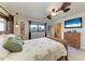 Well-lit bedroom with wicker furniture, ceiling fan, and a window view of the outdoors at 200 Capri Isles Ct, Punta Gorda, FL 33950