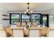Formal dining area featuring a large table, comfortable seating, and views of the screened pool at 200 Capri Isles Ct, Punta Gorda, FL 33950