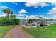 Backyard boat dock with waterfront access, seating area and lush landscaping for outdoor enjoyment at 200 Capri Isles Ct, Punta Gorda, FL 33950