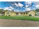 Charming single-story home showcasing a well-manicured lawn, mature landscaping, and a welcoming front entrance at 200 Capri Isles Ct, Punta Gorda, FL 33950