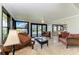 Sunny Florida room showcasing tile floors, a ceiling fan, and comfortable seating with pool views at 200 Capri Isles Ct, Punta Gorda, FL 33950
