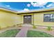 Inviting front entrance with double doors, complemented by manicured landscaping and decorative gravel accents at 200 Capri Isles Ct, Punta Gorda, FL 33950