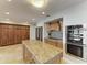 Spacious kitchen with stainless steel appliances, granite countertops, and custom wood cabinets offers ample storage at 200 Capri Isles Ct, Punta Gorda, FL 33950